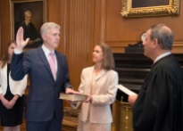 In this photo provided by the Public Information Office Supreme Court of the U.S. Chief Justice John G. Roberts, Jr., administers the Constitutional Oath to the Neil Gorsuch in a private ceremony attended by the Justices of the Supreme Court and members of the Gorsuch family, including wife Louise Gorsuch, Monday, April 10, 2017, in the Justices' Conference Room at the Supreme Court in Washington. Surrounded by family and his soon-to-be Supreme Court colleagues, Gorsuch took the first of two oaths as he prepared to take his seat on the court. (Franz Jantzen/Public Information Office Supreme Court of the U.S. via AP)